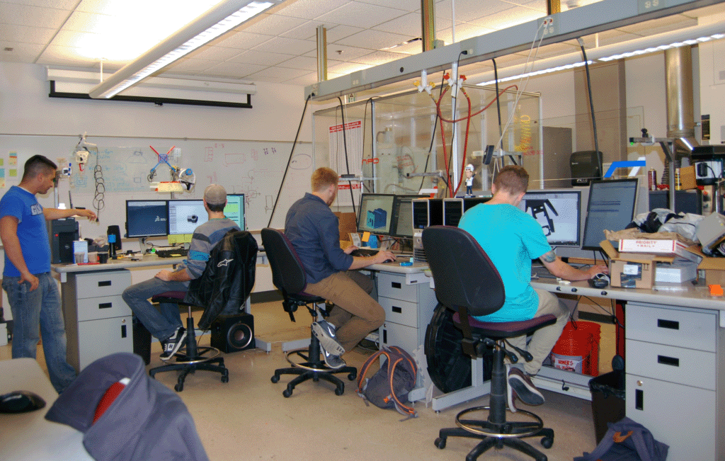 Picture of New Product Development Team student employees at work stations in the NPD Lab.
